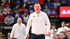 Arizona Wildcats' head coach Tommy Lloyd is coaching during a college basketball game.