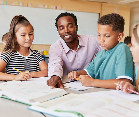 students focusing on school work with teacher
