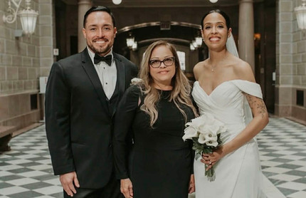 Wedding Officiant Eva Torres-Luciano takes a picture with her couple at Hartford City Hall