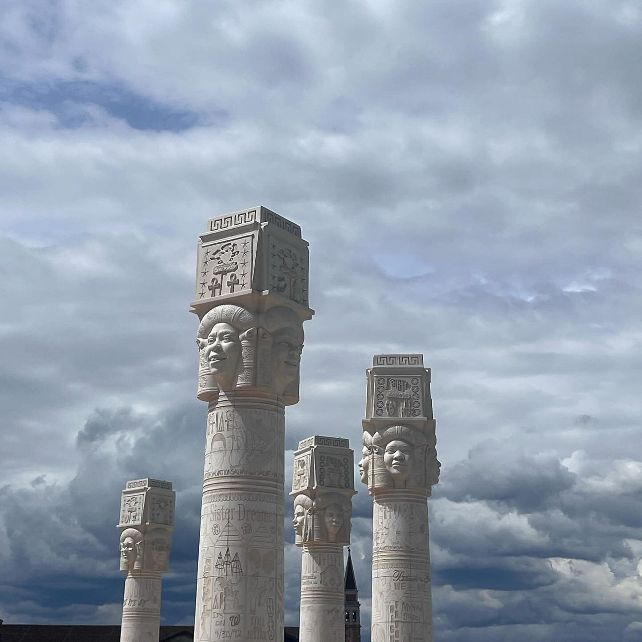 Outside, the work of Lauren Halsey looks over the Arsenale. The columns are a mix between ancient and contemporary culture. It is also holding up the Black and African American diaspora and its history, and with modern-day pop culture in our lives now.