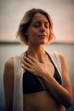 Guided touch and breathwork during a somatic healing session, supporting body awareness and nervous system regulation helping a client to process emotions.