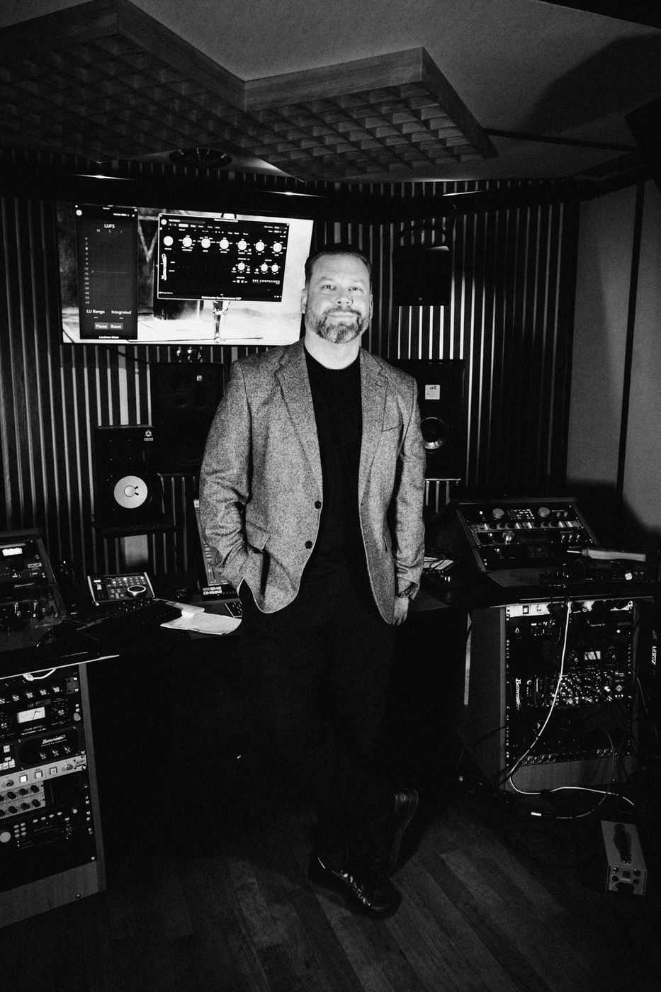 Maro in his studio, surrounded by Bettermaker hardware, with the Bettermaker Bus Compressor plugin on screen