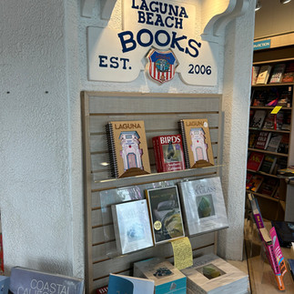 Bookshelf under "Laguna Beach Books, Est. 2006" sign