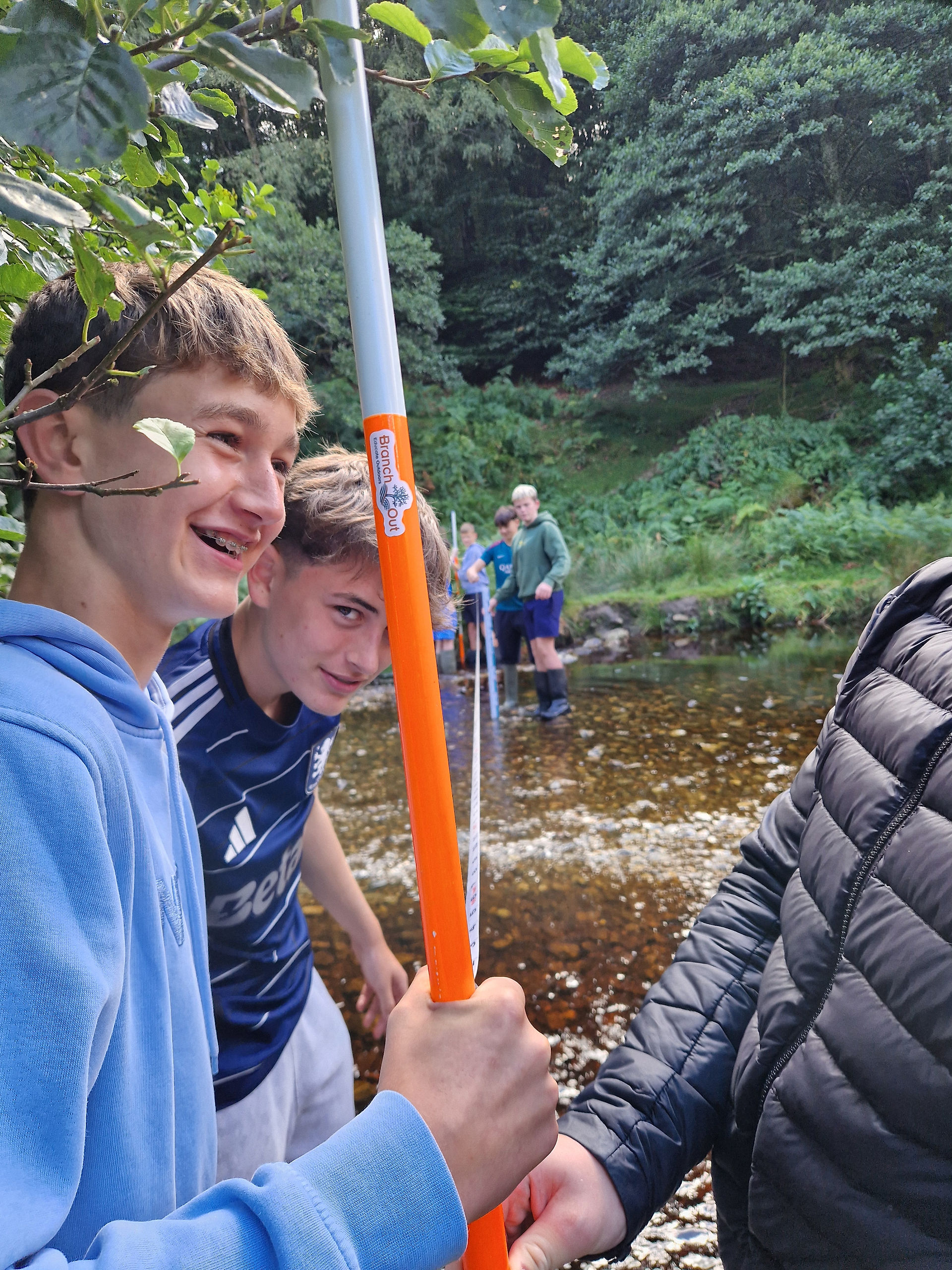 Students recording field observations for CBA2 geography write-up during outdoor learning session Ireland