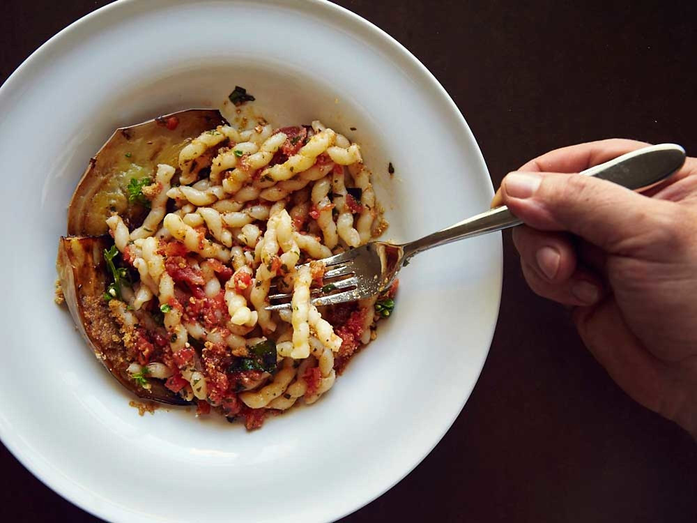 Corkscrew Pasta with Eggplant and Tomato-Basil Pesto (Busiate con Pesto alla Trapanese) The North African tradition of serving almonds in savory dishes is reflected in the pesto for this dish, in which the nuts are mixed with tomatoes and basil and tossed with busiate, the traditional corkscrew-shaped pasta from Trapani.