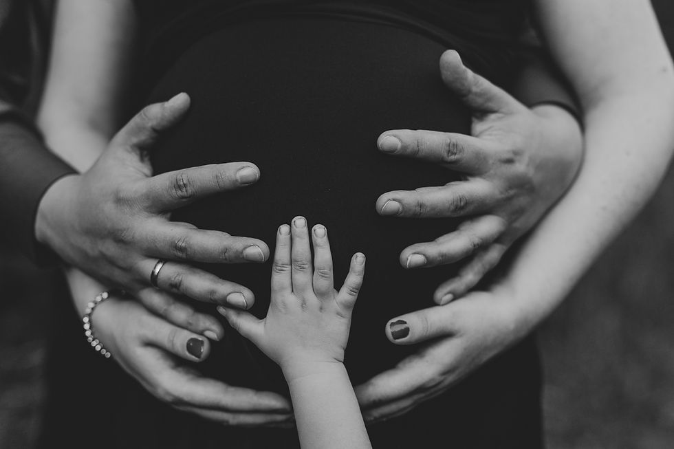 London maternity photography, pregnancy photo shoot, hands holding pregnant belly, family portrait, parents and child portrait