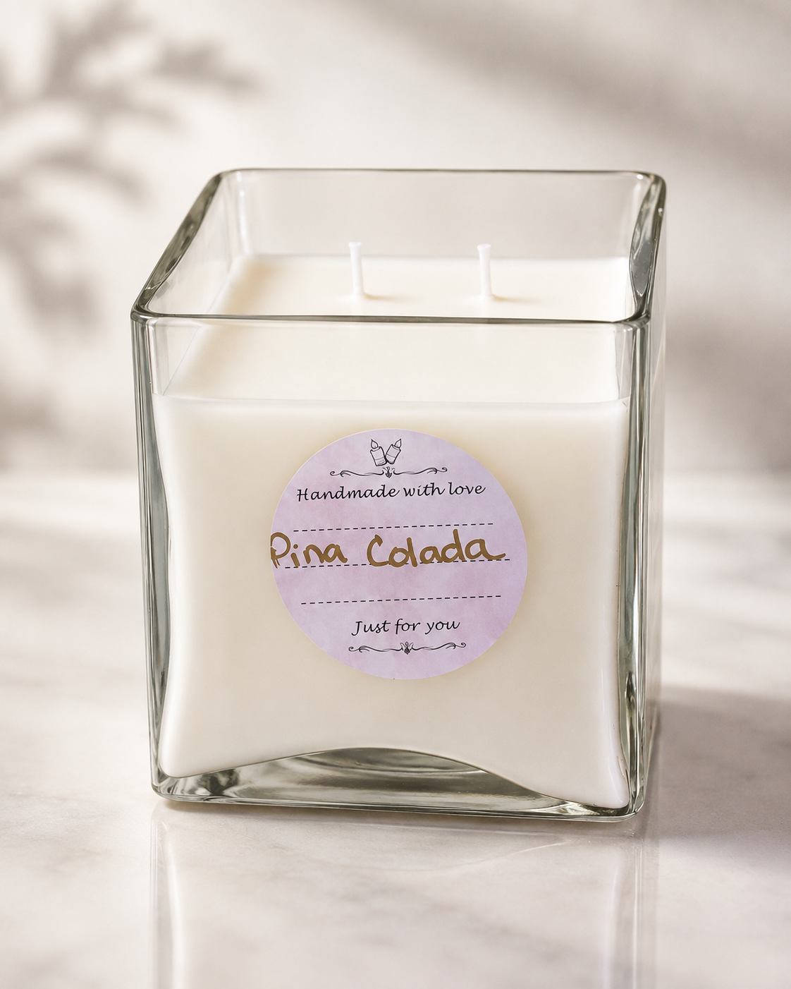 Pina Colada scented candle in a square glass jar