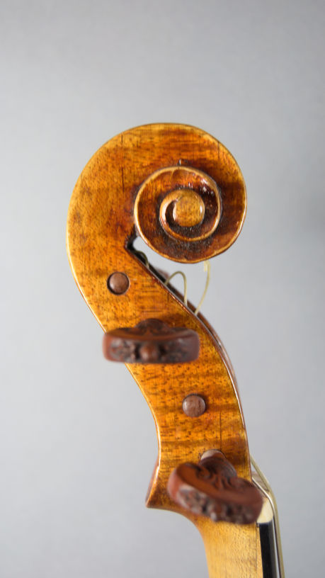 Douglas Cox Baroque Violin in front of grey backdrop.