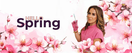 Michelle Herasme, board-certified nurse practitioner at Herasme Beauty in Englewood NJ, holding a syringe surrounded by cherry blossoms with a Hello Spring banner
