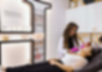 Michelle Herasme performing an aesthetic injection on a client in a modern, luxurious trea