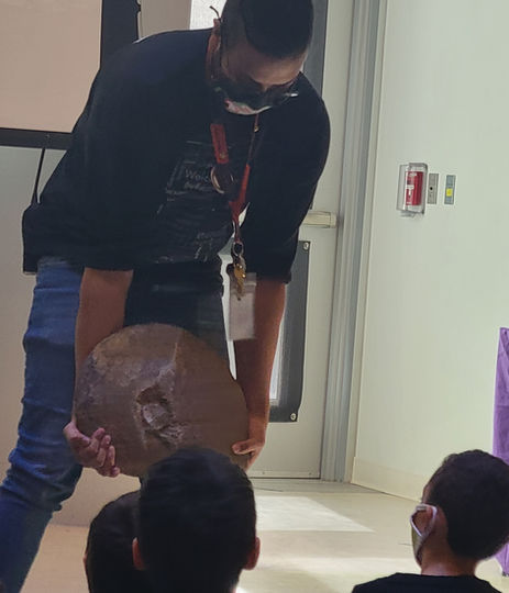 Instructor shows students a large fossil