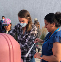 teachers making cotton candy at an event