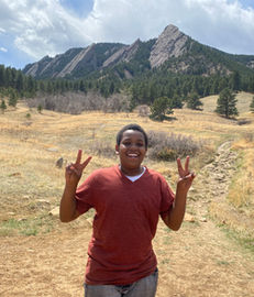 Happy person peace signs, Flatirons mountains background
