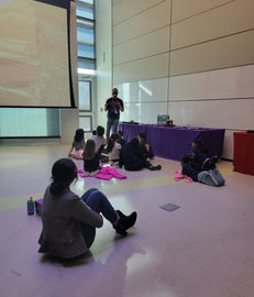 Storyteller presenting to children; axlacademy