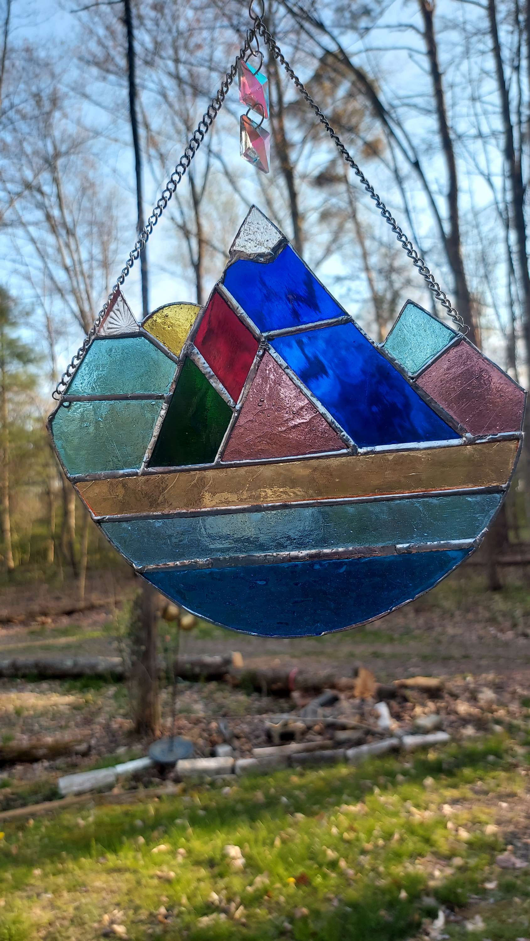 Mountain scene with sunrise and square cut crystal rainbow optical prism