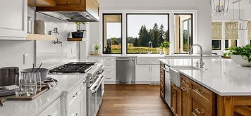 Modern farmhouse kitchen in the Riverbend Plan by Apex Homes Florida featuring custom cabinetry and a large island