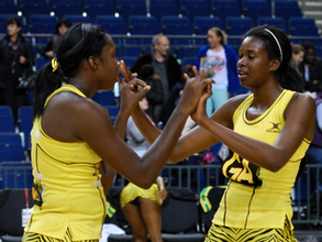 Jamaican Jhaniele Fowler-Nembhard high fives her team mate Romelda Aiken-George