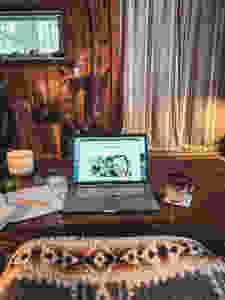 A cabin scene with my computer and calendar working on blog traffic and views.