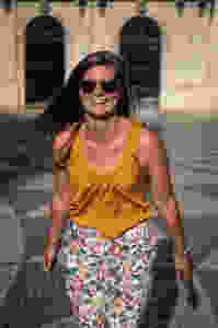 Steph Castelein from Each Day Slow laughing while traveling in Lisbon, Portugal.