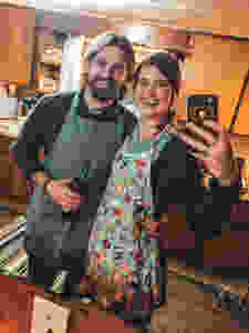 All smiles while we cook with wine and fun aprons!