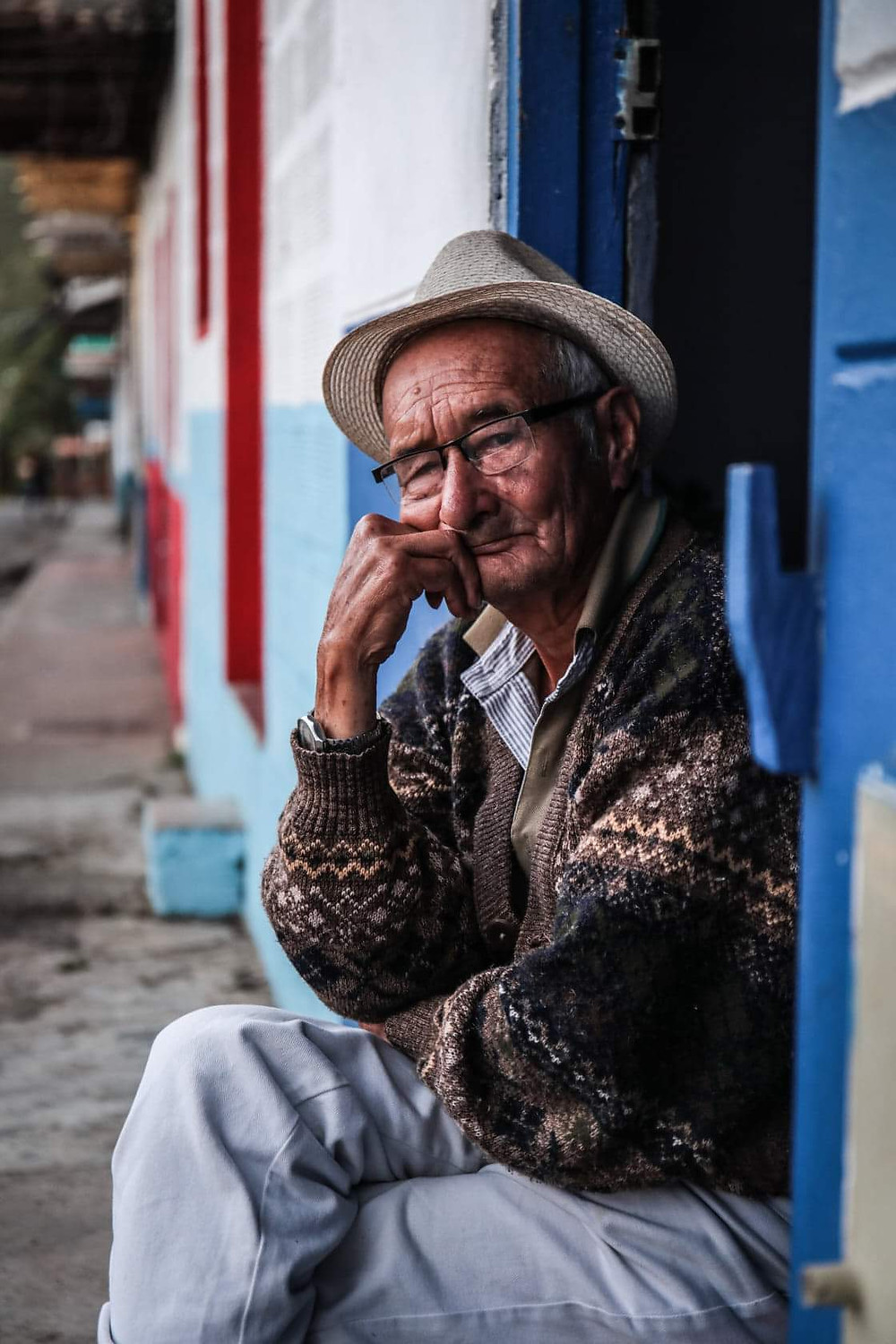 Man sitting in doorway in Jardin, Colombia.