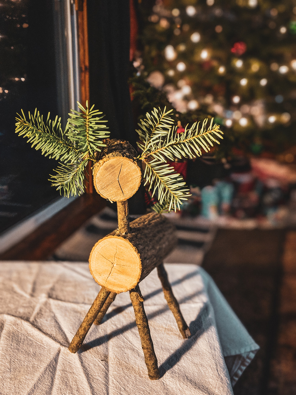 The completed DIY reindeer in front of our Christmas tree.
