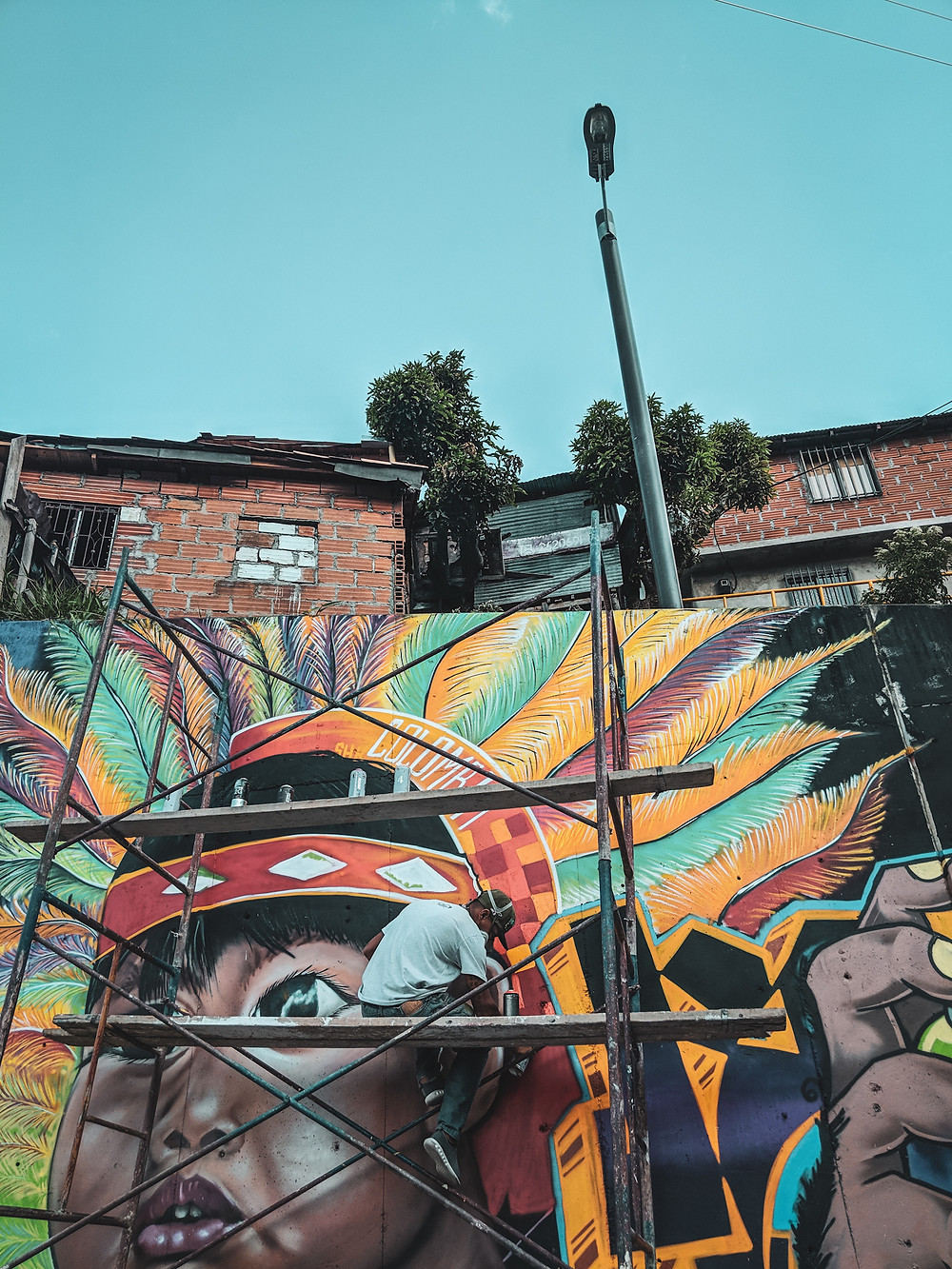 An artist creating a graffiti mural in Comuna 13 in Medellín, Colombia.