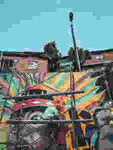 An artist creating a graffiti mural in Comuna 13 in Medellín, Colombia.