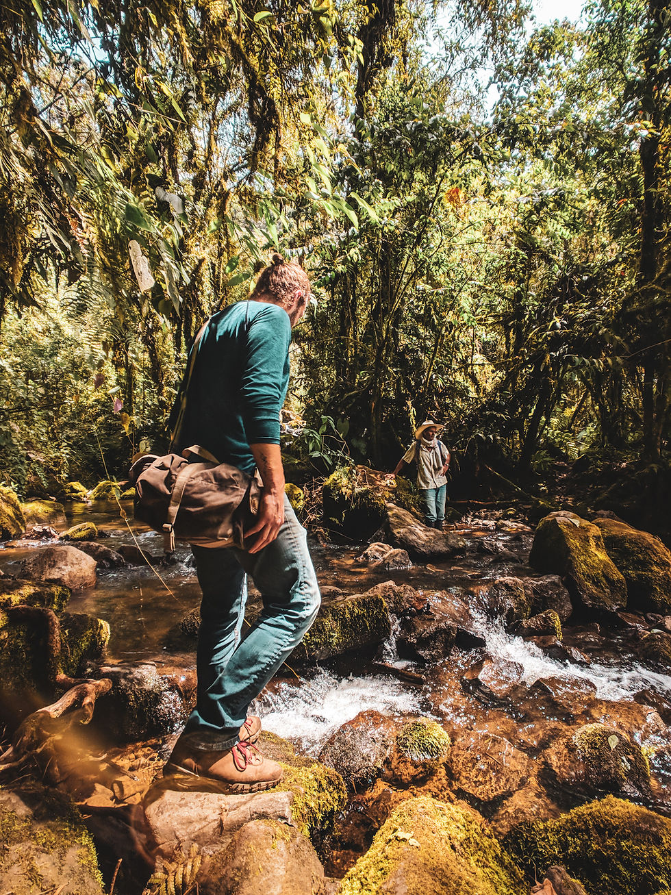 Hiking across rivers in Jardin, Colombia.