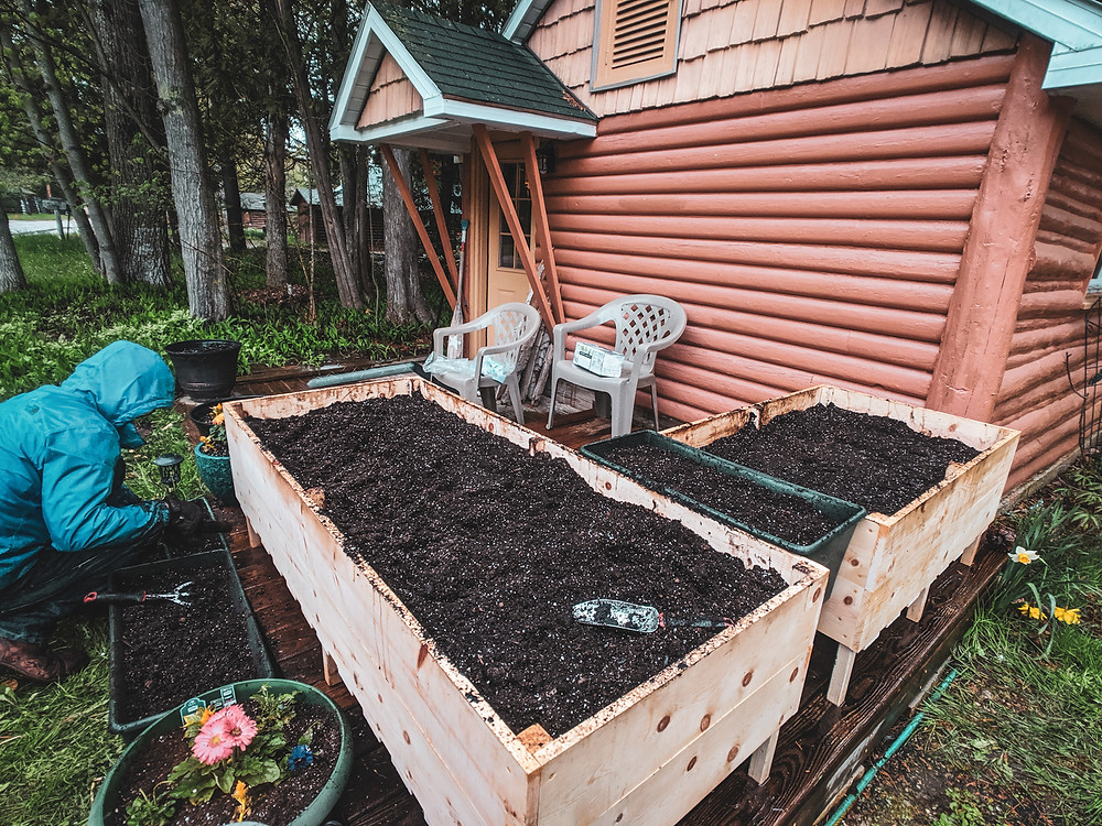 The completed DIY raised garden beds outside of our tiny cabin home in Northern Michigan. They were designed by Steph Castelein from the Each Day Slow blog.