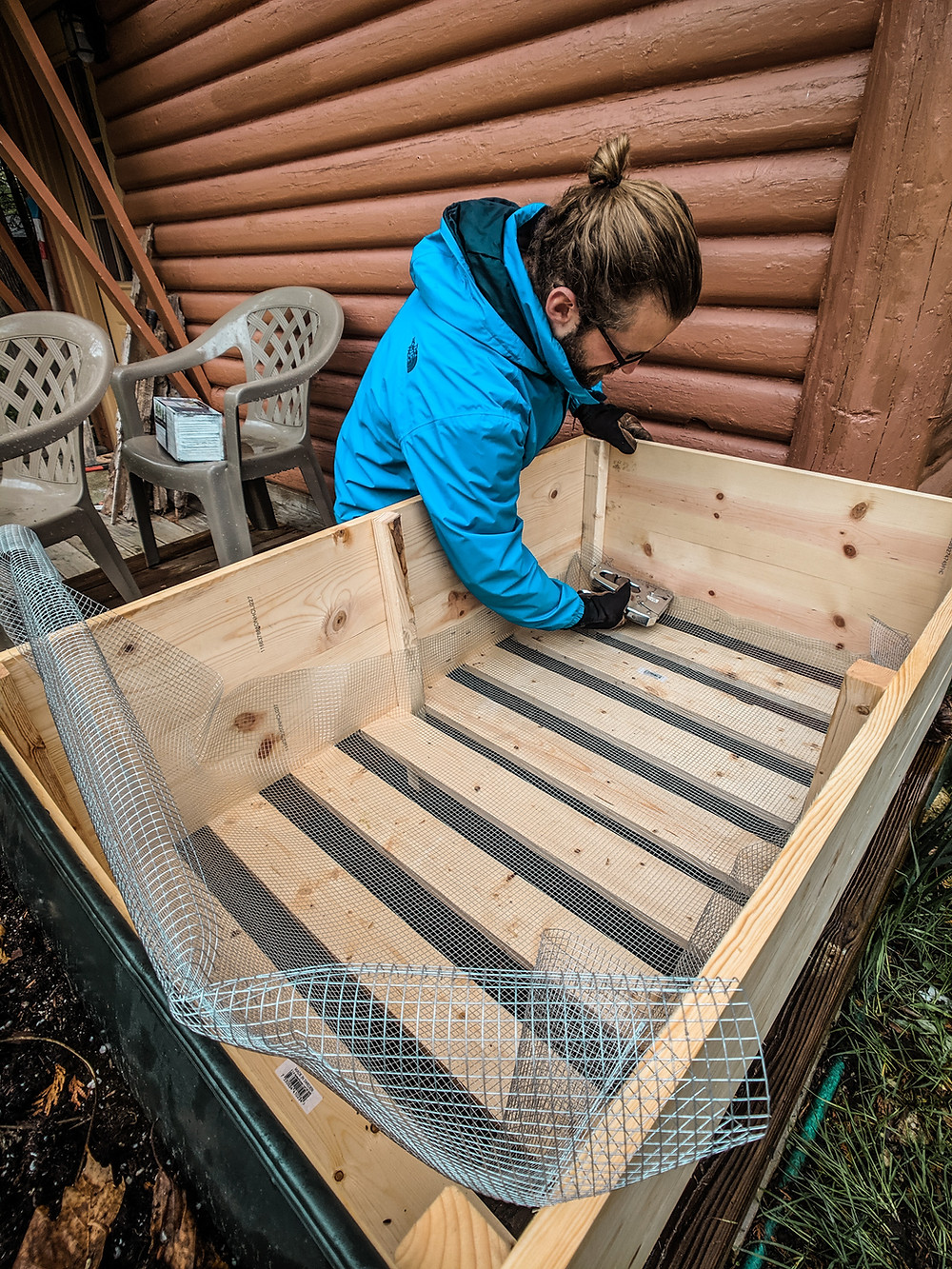 Putting in hardware cloth to create our DIY raised garden beds in Northern Michigan. This was done by Steph Castelein at the Each Day Slow blog.