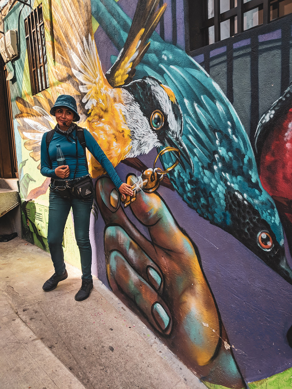 Guide explaining graffiti murals in Comuna 13 in Medellín, Colombia.