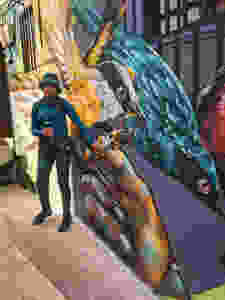 Guide explaining graffiti murals in Comuna 13 in Medellín, Colombia.