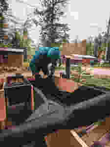 Attaching the weed control fabric to our DIY raised garden beds in Northern Michigan designed by Steph Castelein at the Each Day Slow blog.