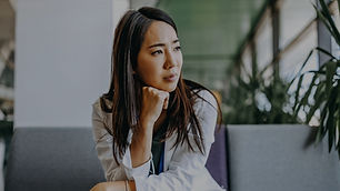 Man sitting with his head in his hands at a desk, appearing stressed.