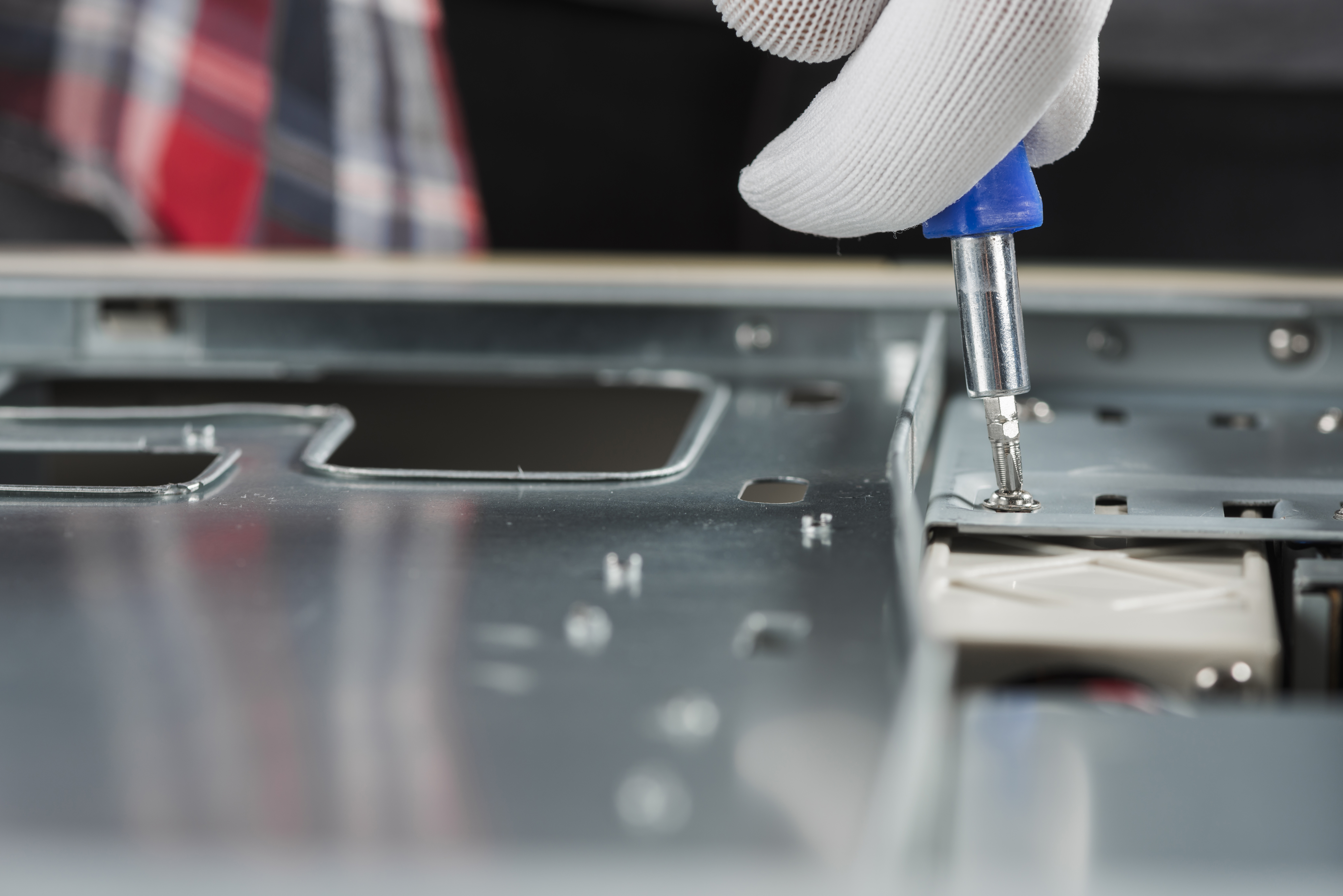 close-up-technician-hand-fixing-screw-computer-slot-with-screwdriver.jpg