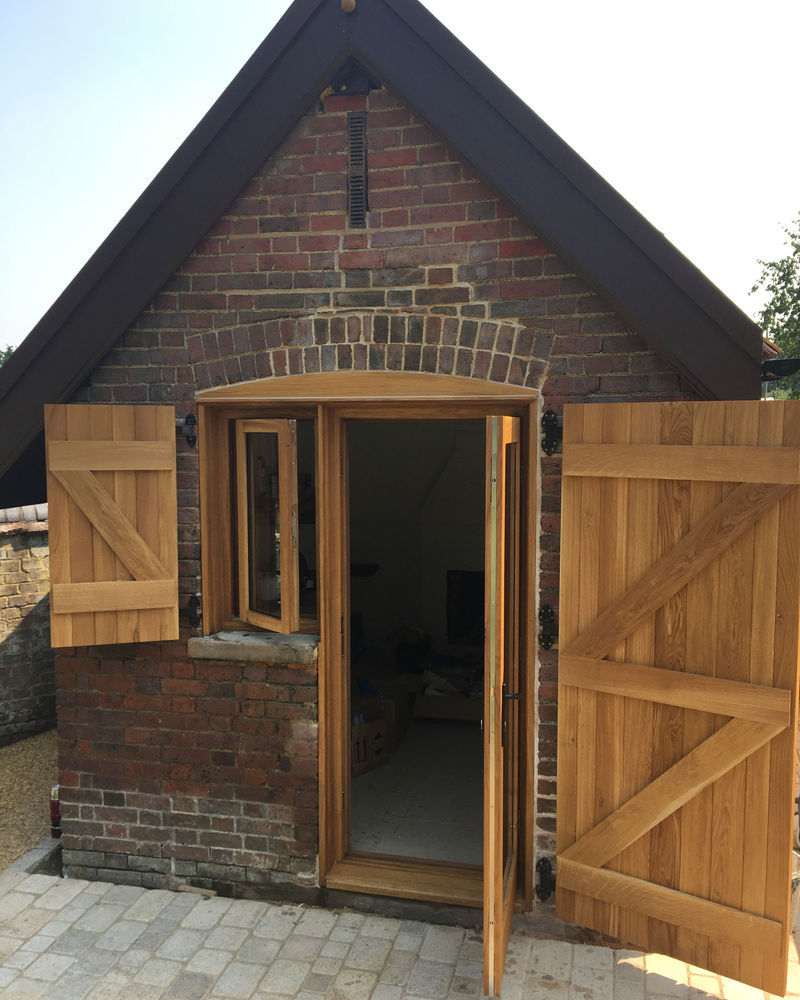 Window and door with plank-style opening shutters, made to match the original