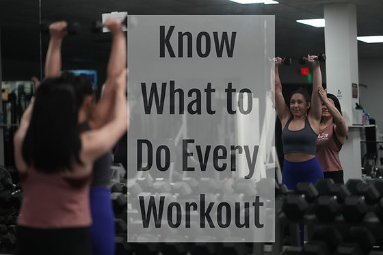 Personal trainer coaching a female client through a dumbbell shoulder press with proper form at Elite Personal Training in Lee's Summit, Missouri.