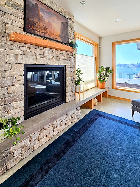 a granite fireplace with wood mantle