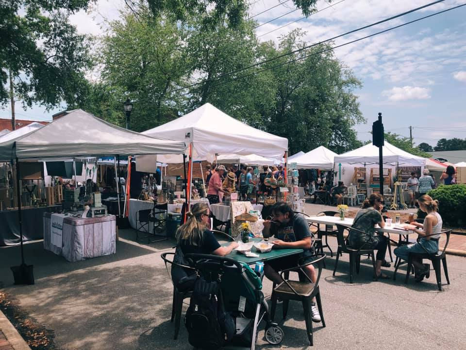 High angle view of a bustling market with colorful stalls and shoppers