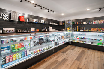 Store photo of merchandise including bongs, cartridges, rolling trays, cannabis flower, etc.