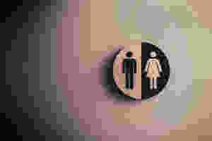 male and female bathroom label in wood