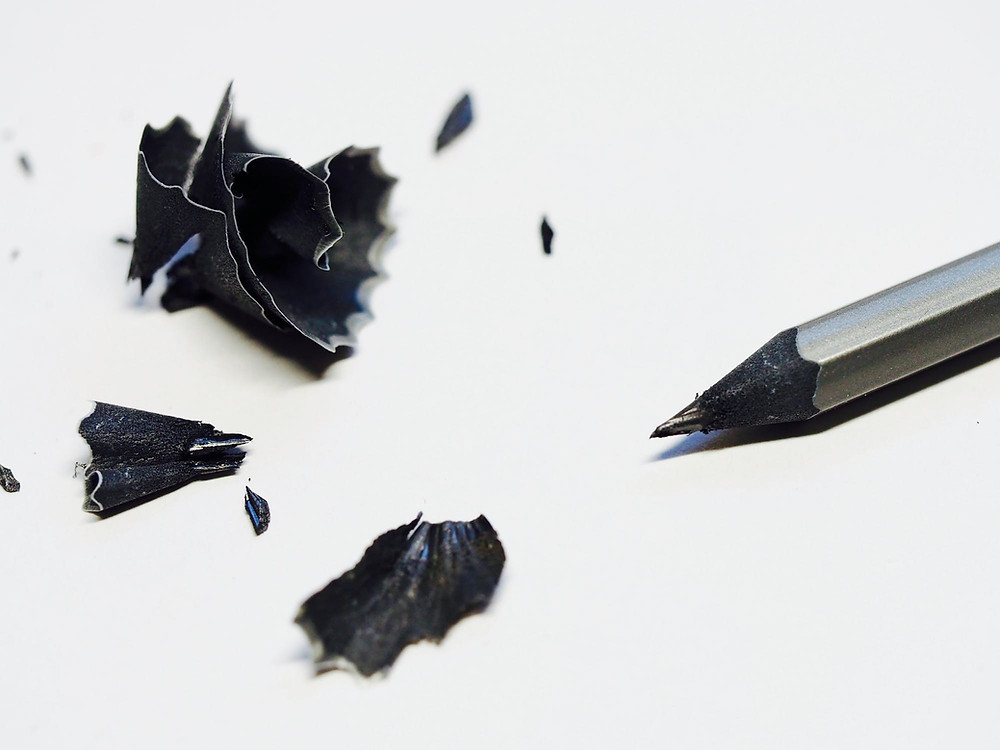 black pencil, white sheet, with shavings