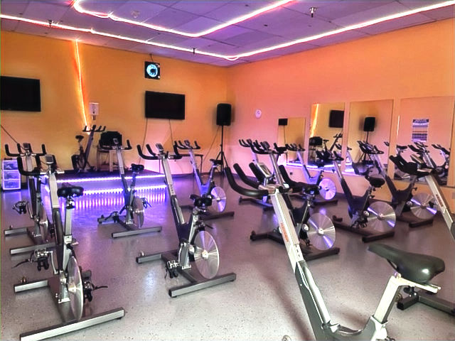 Eye-level view of a bright fitness studio with exercise mats and equipment neatly arranged