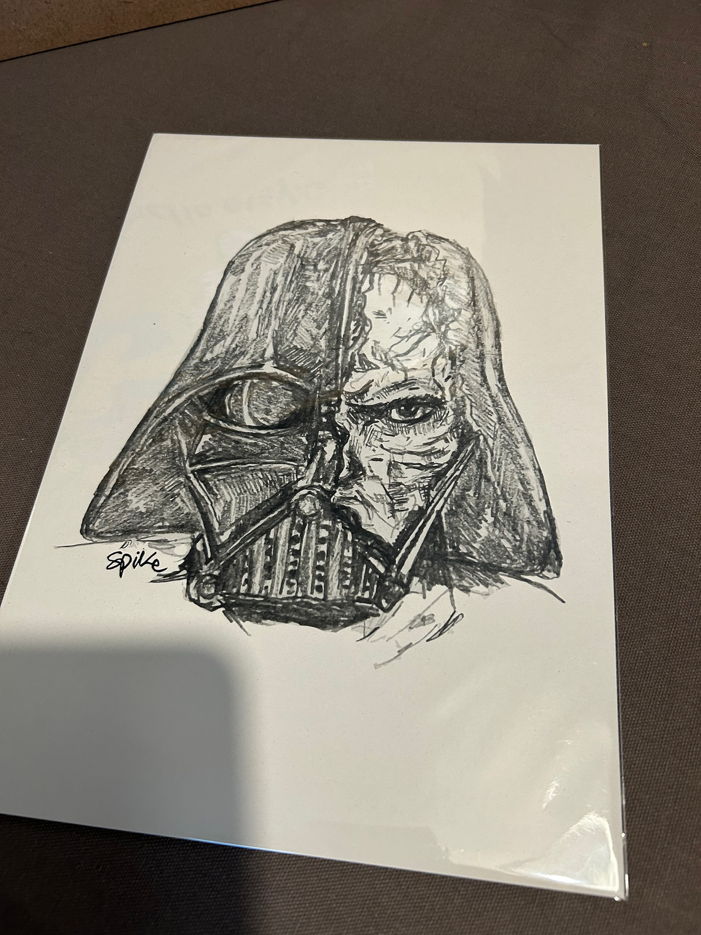 Detailed drawing of Darth Vader's damaged helmet revealing a face.