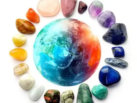 Colorful gemstone circle around Earth on dark background, natural healing crystals concept, vibrant polished gemstones energy balance theme
