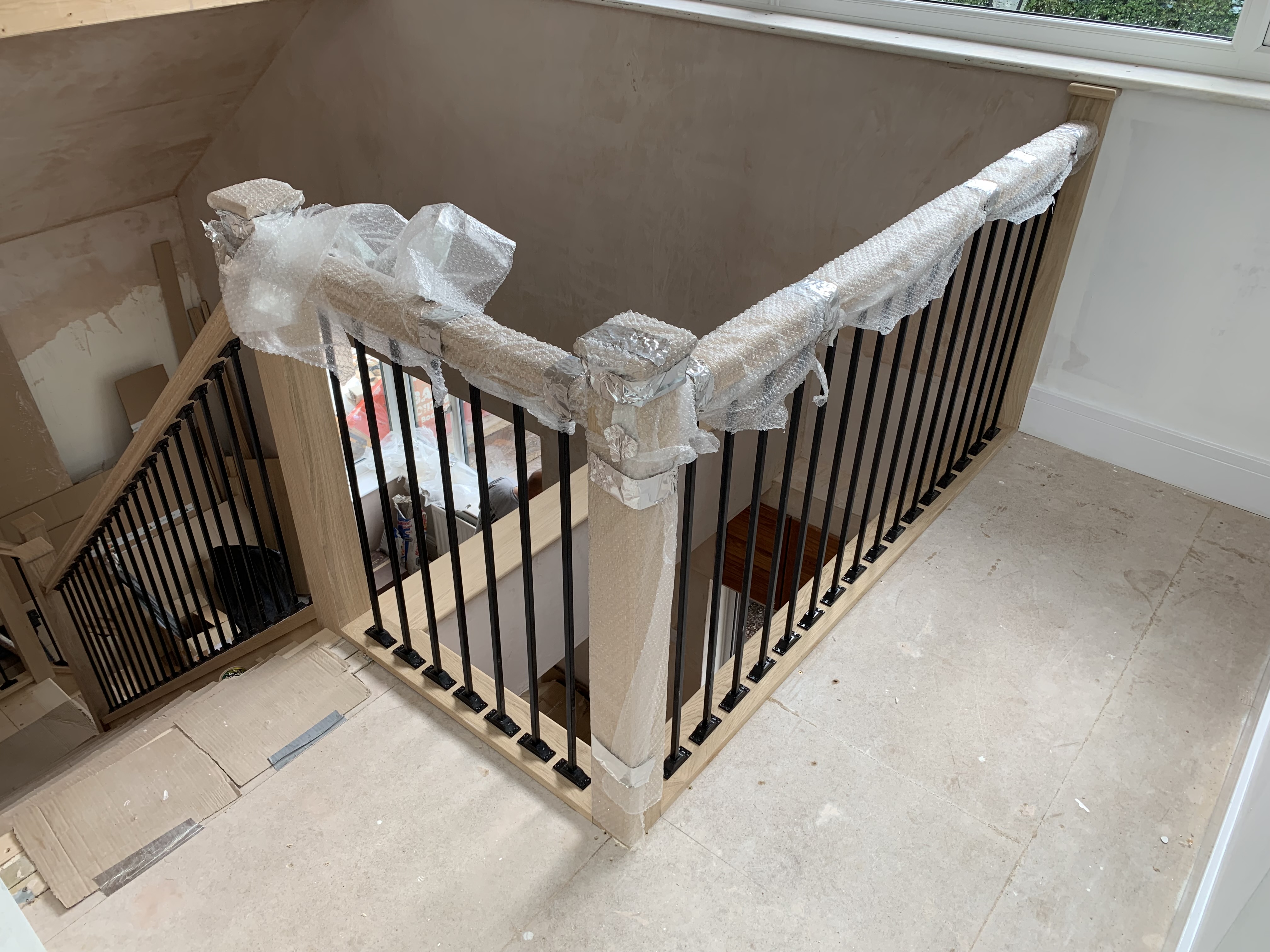Solid oak staircase with oak feature treads, oak stairparts and metal spindles