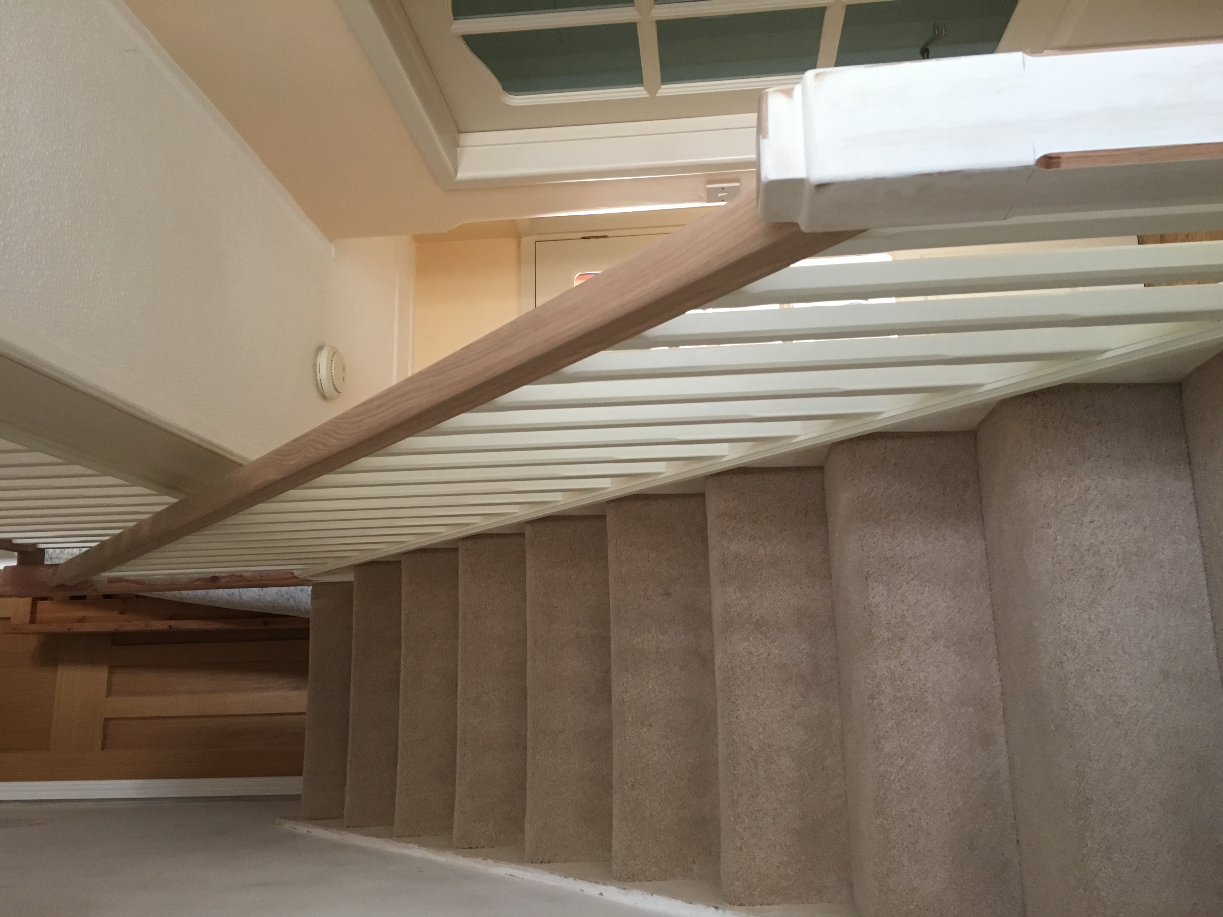 Oak handrail with primed stop-chamfered spindles and baserail