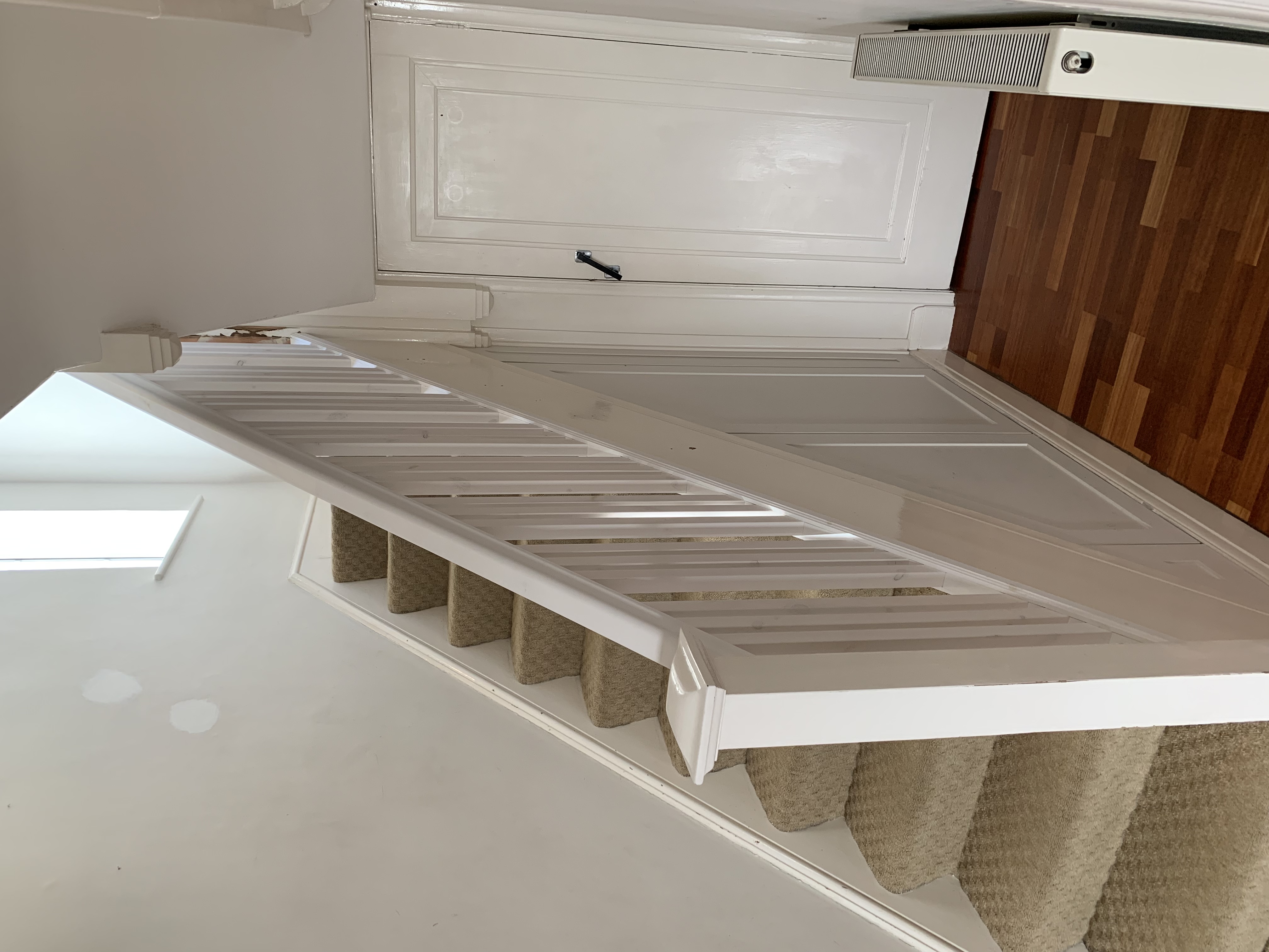 Primed handrail with primed spindles grouped in 3s