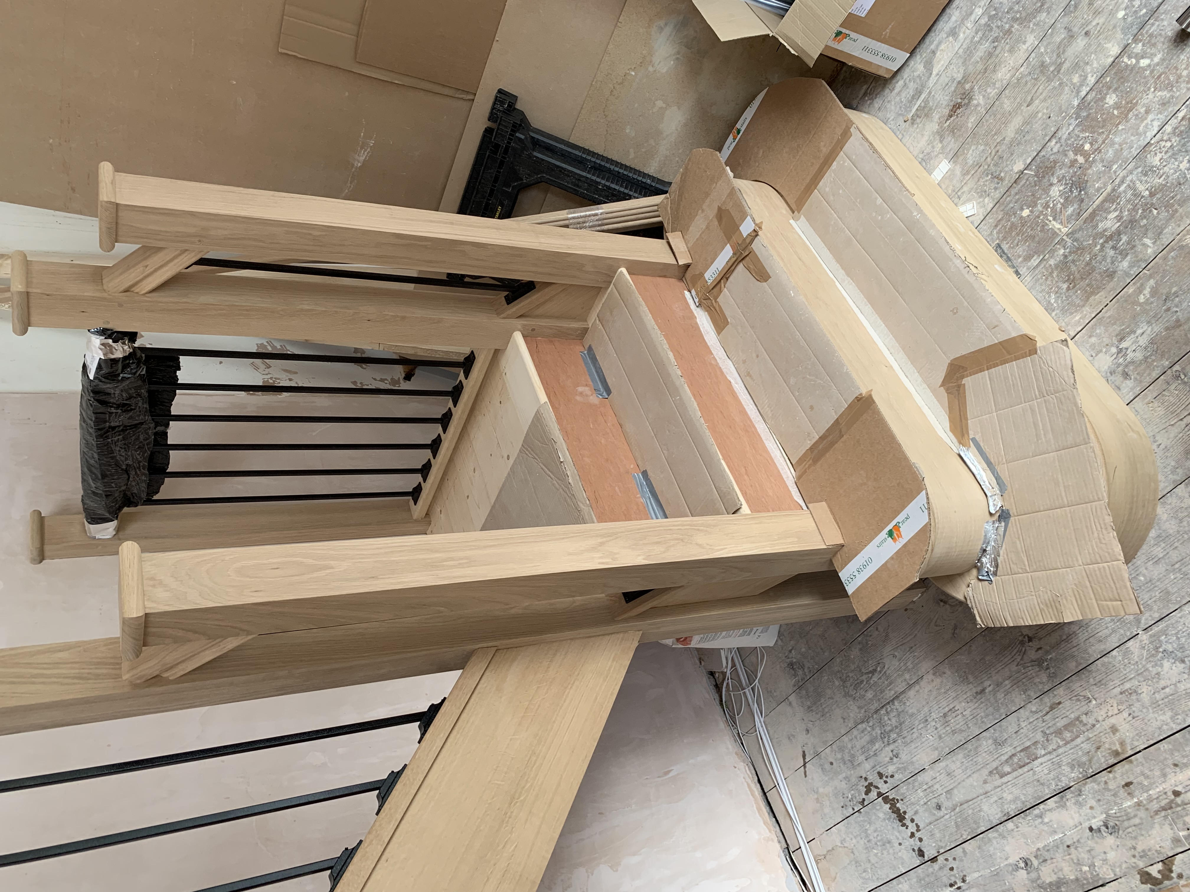 Solid oak staircase with oak feature treads, oak stairparts and metal spindles